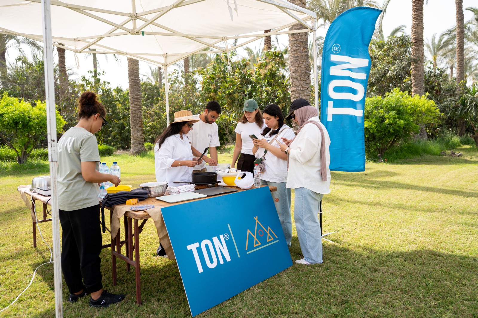 Team collaborating around a TON-branded outdoor activity station