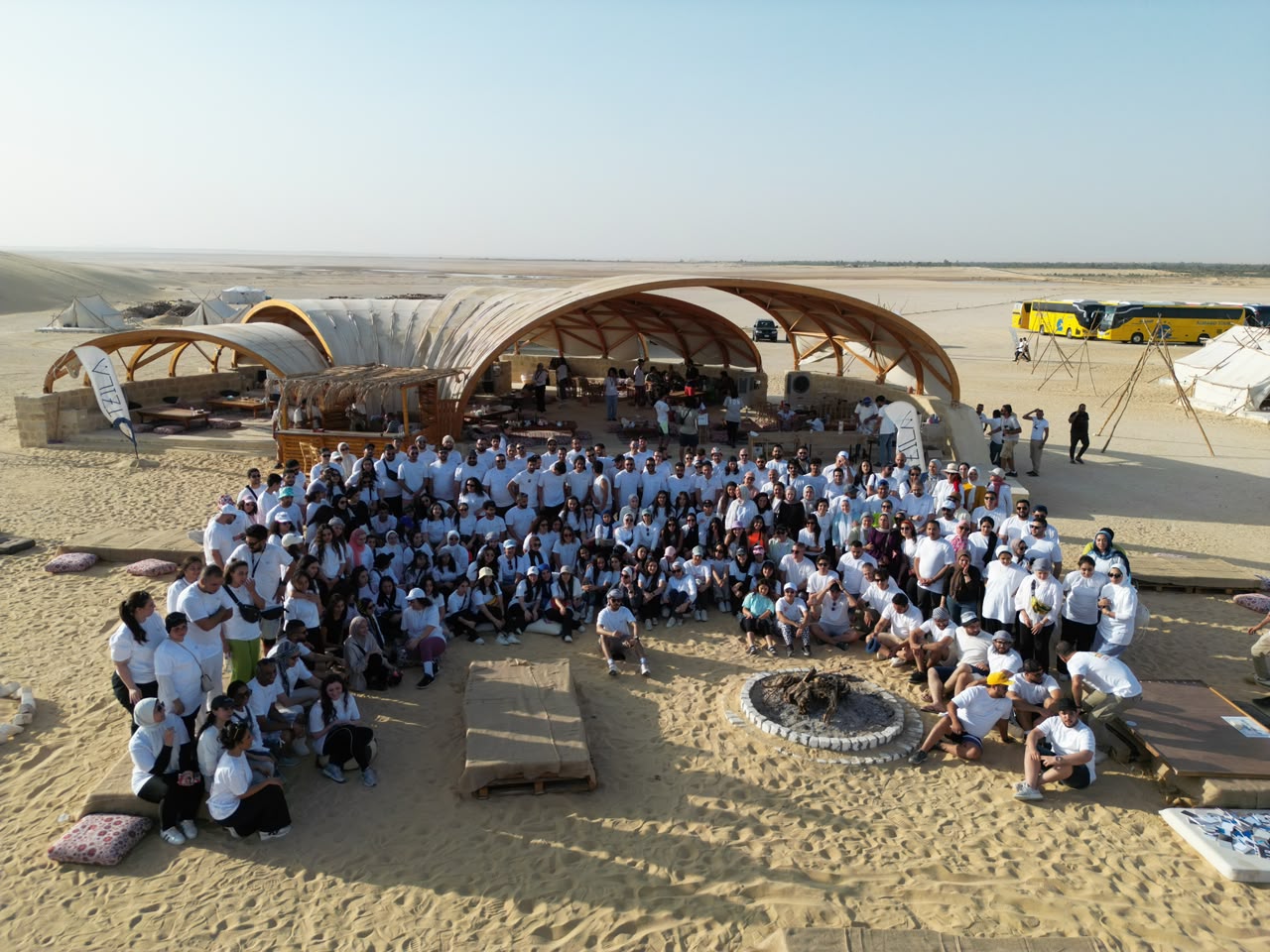 Large corporate group gathered at a desert camp venue
